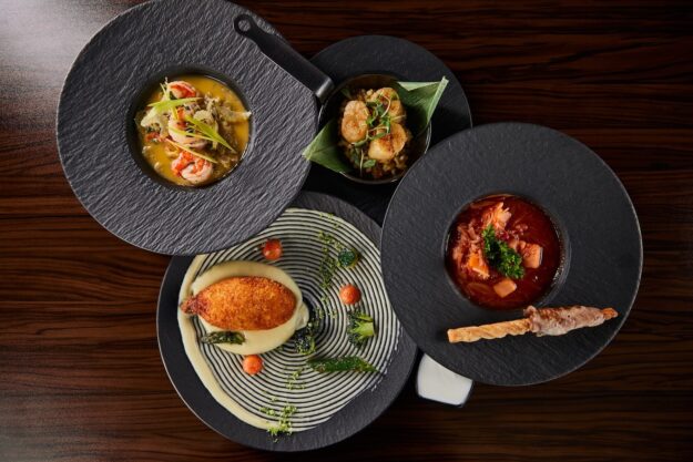 top-view-of-delicious-restaurant-dishes-on-wooden-2022-12-16-18-51-48-utc